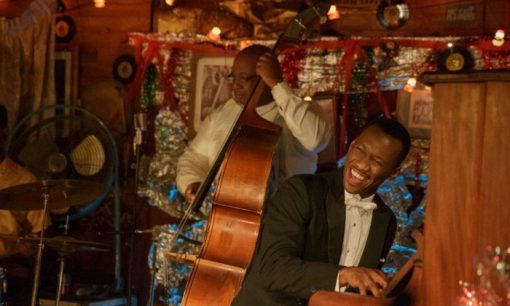 Mahershala Ali as Don Shirley playing piano in Green Book